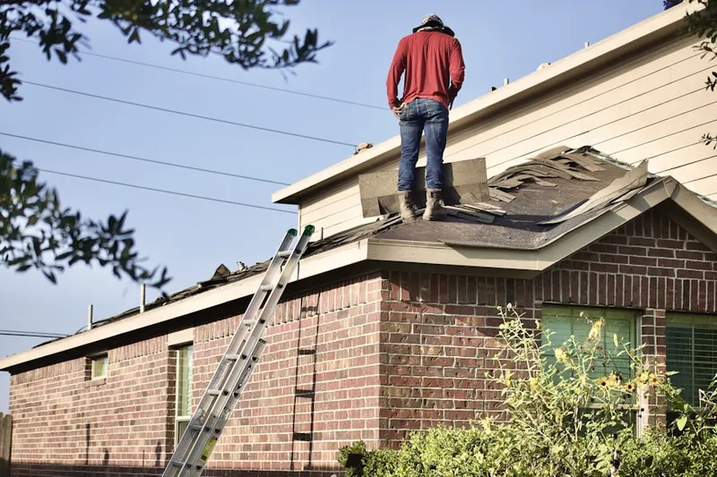 Professional roofer working on a residential roof in Wolfeboro